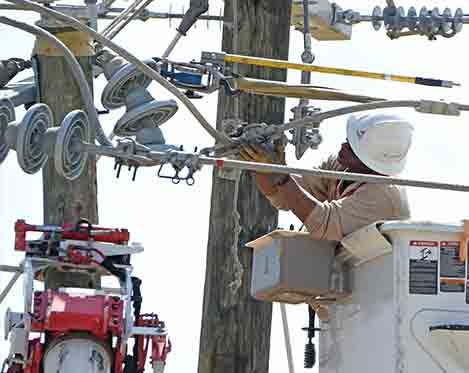 Line workers working to fix a transmission line